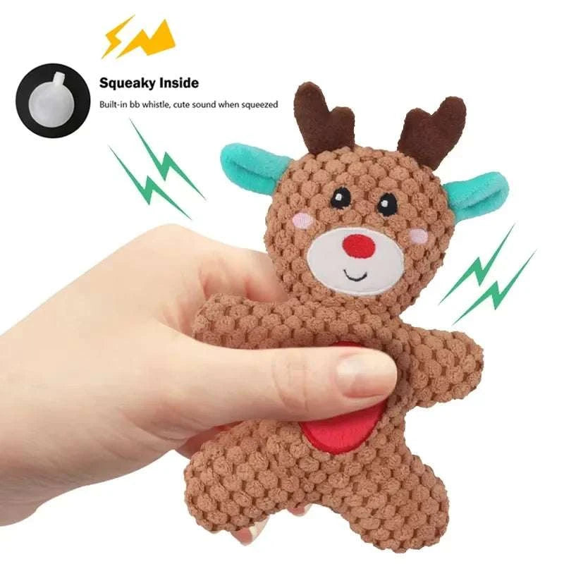 Hand holding Xmas Pet Dog Plush Chew Toy reindeer with squeaky sound feature